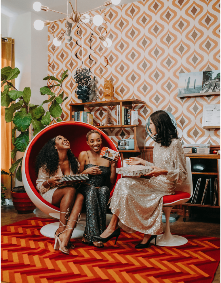 3 Women of Color Exchanging gifts
