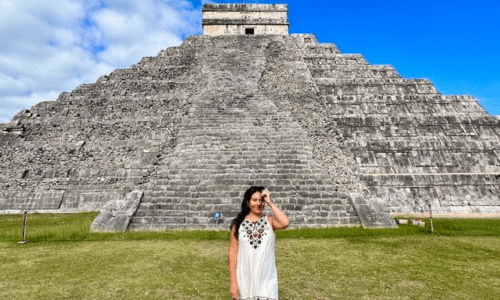 Latina Woman in front of Chichen Itza wearing a traditional Mayan dress