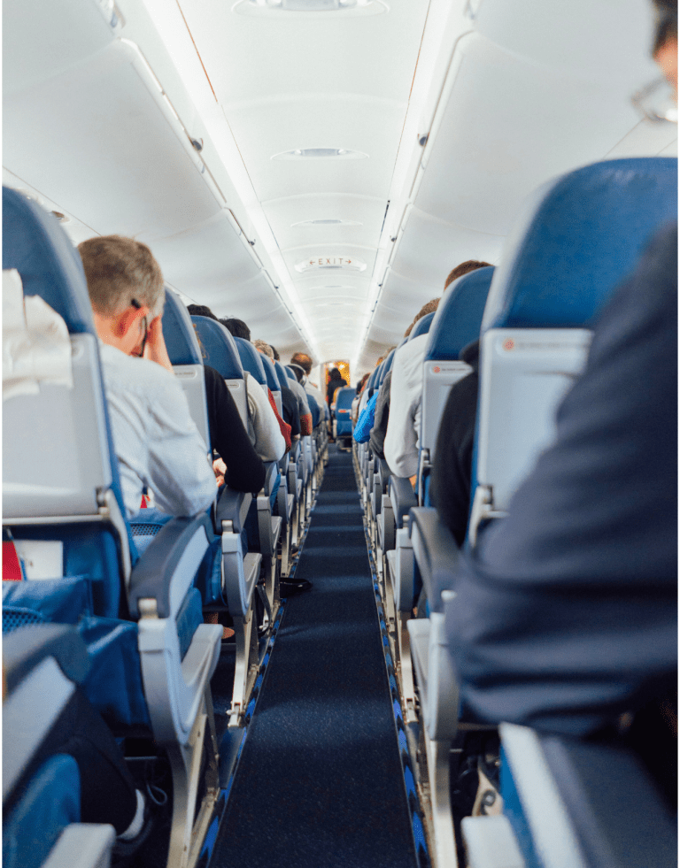 Image of the aisle from the back of plane showing a full flight