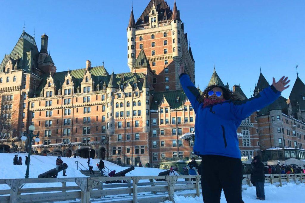 Fairmont Château Frontenac Review : A latina woman (the author)  jumping in front of Chateau Frontenac during her visit in winter 2016 