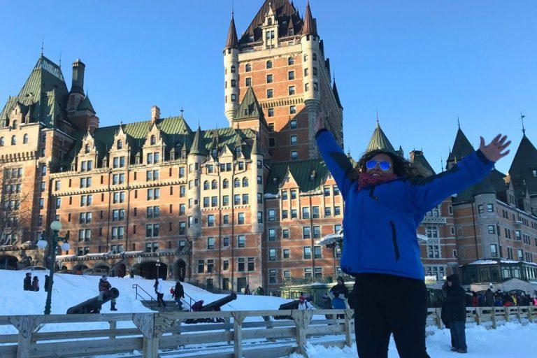Fairmont Château Frontenac Review : A latina woman (the author) jumping in front of Chateau Frontenac during her visit in winter 2016