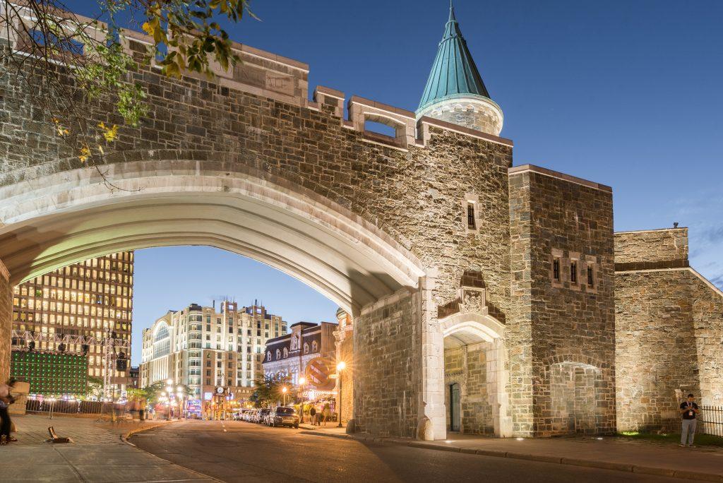 St-Jean Gate in the evening, where you can see passersby heading inside the fortifications - summer Quebec City Travel Guide