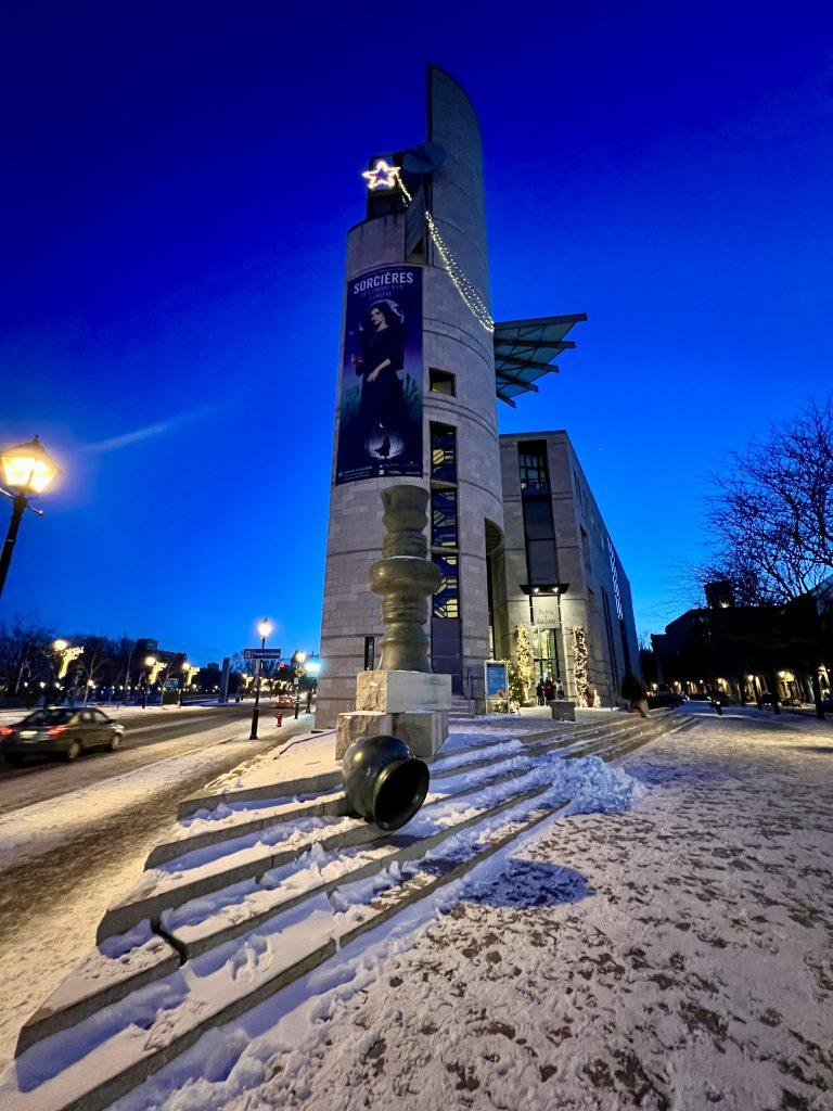 Pointe-à-Callière Museum in Old Montréal at dusk, featured in The Queen of Trips guide on where to stay in Montréal 2026.